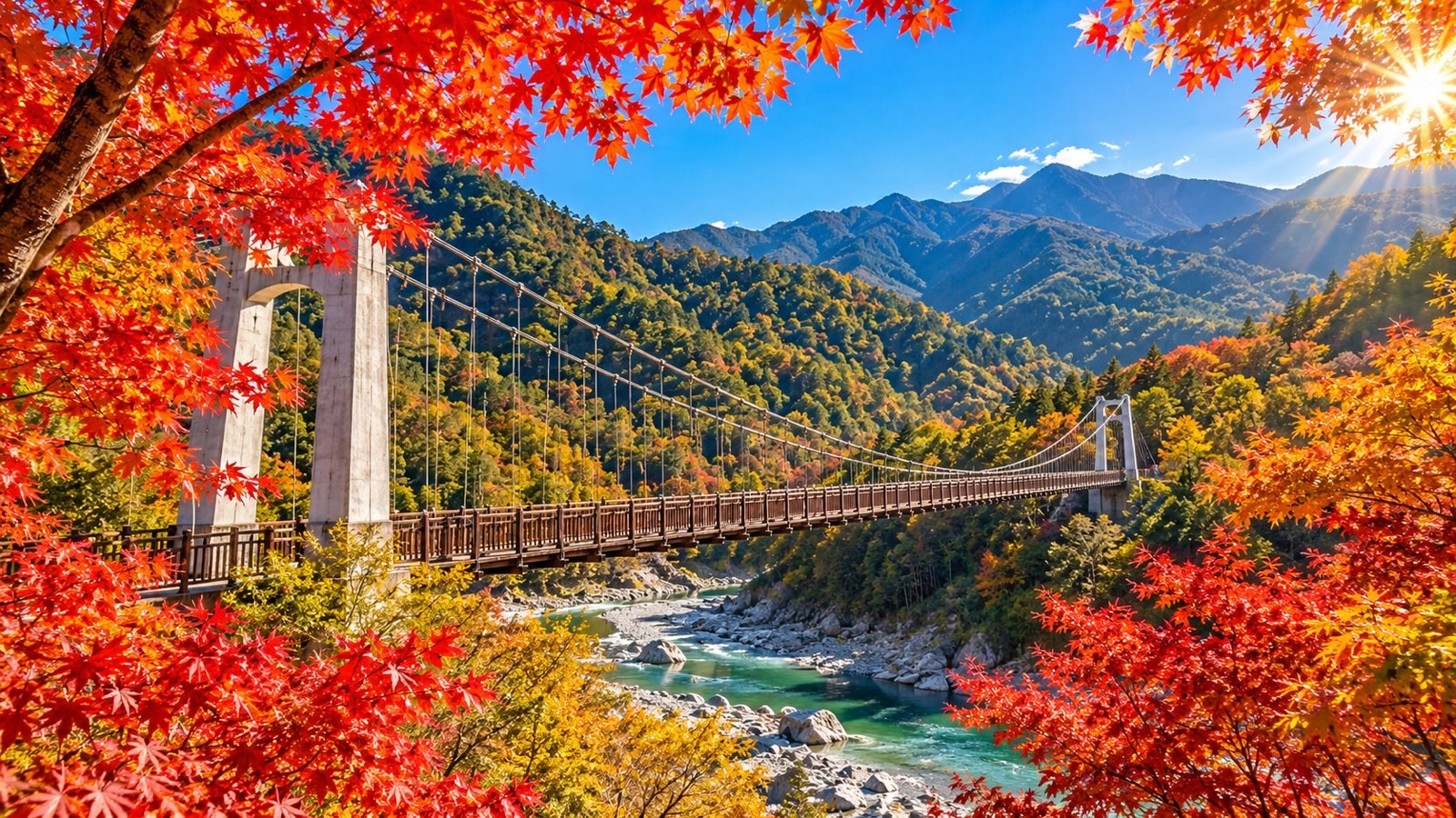 Suspension bridge in a valley surrounded by red maples