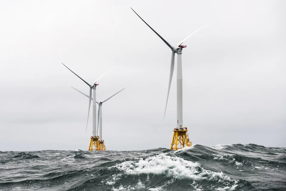 Block Island Wind Farm turbines on yellow jacket foundations amid heavy seas